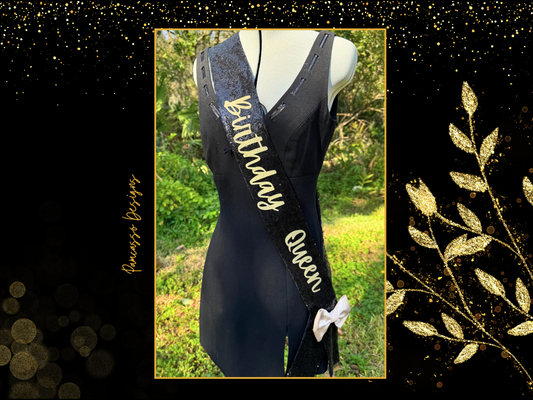 Celebrate in style with this dazzling black sequin “Birthday Queen” sash, designed to make any birthday unforgettable! Crafted with shimmering black sequins, this sash catches the light and adds sparkle to every moment. The bold “Birthday Queen” text stands out beautifully, making it clear who the star of the day is. A luxurious gold satin bow adds an elegant touch, giving a pop of contrast and a touch of sophistication.