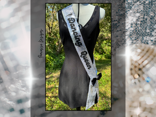 Introducing our dazzling Silver Sequin Sash, designed to add a touch of sparkle to any occasion! This glamorous sash features shimmering silver sequins with bold black lettering, making it a perfect accessory for celebrations. It’s finished with a chic black satin bow, adding an elegant touch to the eye-catching design. Shown with “Dancing Queen,” but fully customizable with your preferred text